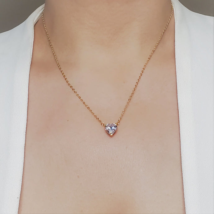 The dainty Amor Necklace is an elegant, charming piece that adds the perfect dose of romance and whimsy to any outfit. A single Zircon pendant is strung on a delicate chain in a heart shape.